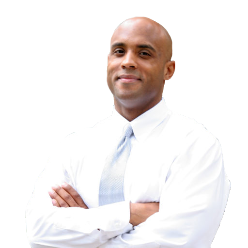 A black man with a bald head in a white button up shirt with a light blue tie.